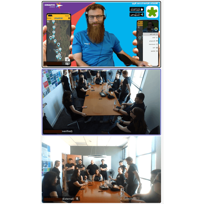 Remote host briefing corporate team on a digital treasure hunt via video call while team gathers in office meeting room
