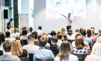 Large corporate kick off conference in Ireland with keynote speaker, branded staging, and professional event setup by Dynamic Events.