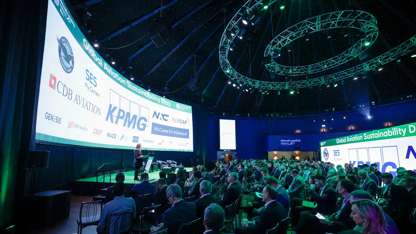 Corporate conference in Ireland with full audience, professional stage setup, and branded screens at Global Aviation Sustainability Day