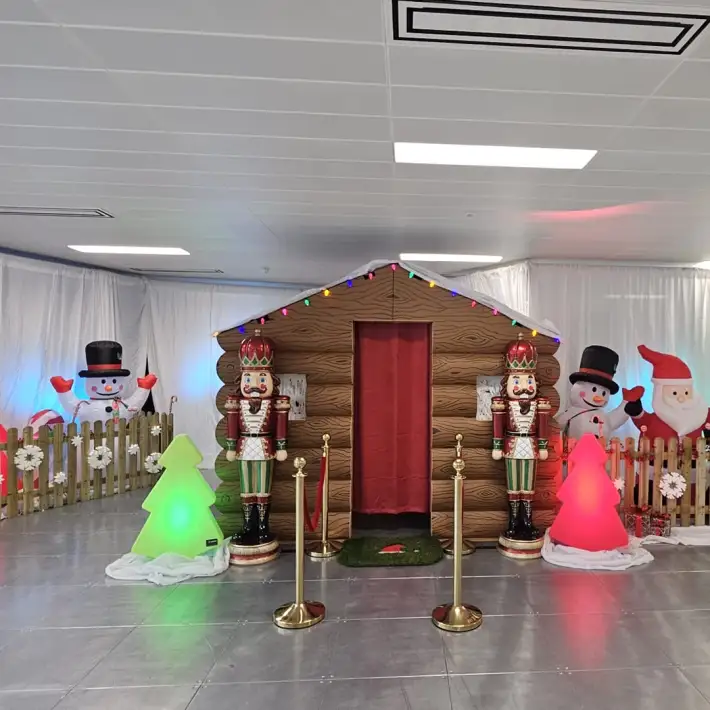 Corporate family Christmas event with Santa’s grotto, nutcrackers, fairy lights, and festive office decorations.