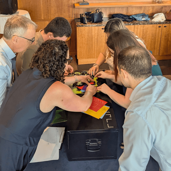 People figuring out a puzzle to unlock the next codebreaker box 